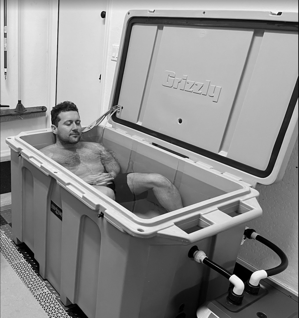 A photo of a man enjoying a cold plunge in his Desert Plunge ice bath.